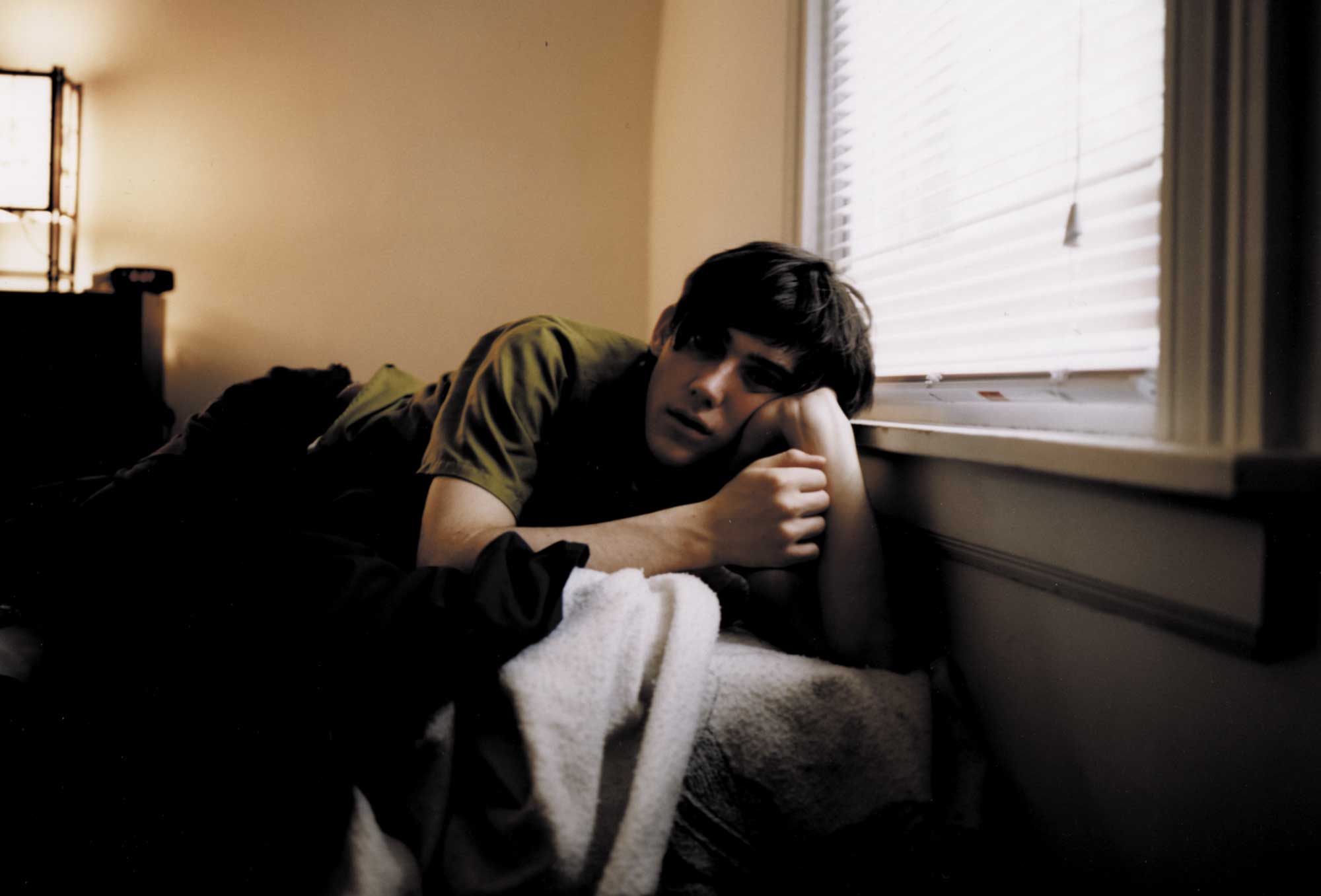 Conor Oberst laying on a couch